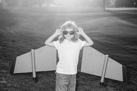 Child imagination with cardboard wings dream to be pilot. Creative and innovation concept. Success kids and leader concept.の写真素材