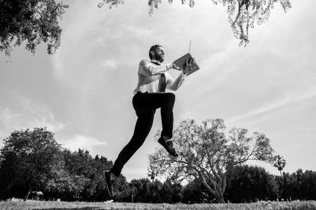 Fast business concept. Running business man with laptop.の写真素材