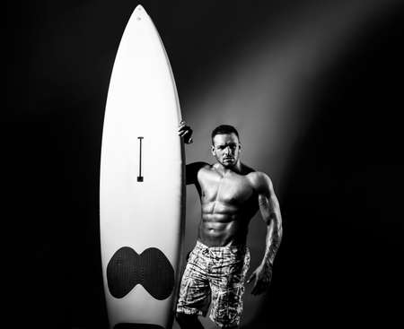 Sexy muscular summer boy. Handsome man with serf board or surfboard with athlete, fit and firm body.の写真素材