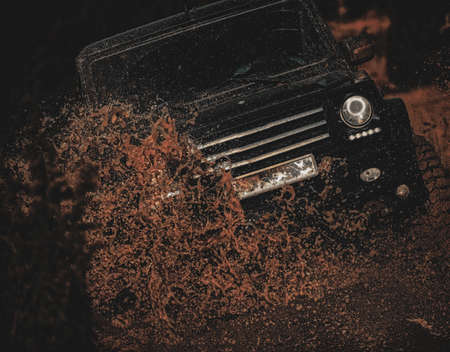 Offroad travel on mountain road. Off-road vehicle goes on the mountain. Off road sport truck between mountains landscape. 4x4 travel trekking. Mud and water splash in off the road racing.の写真素材