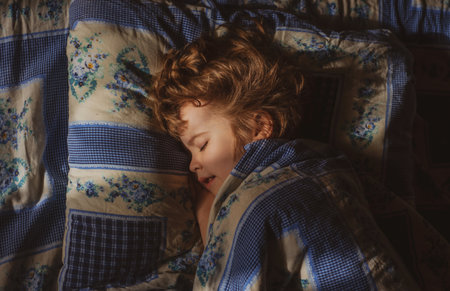 Blonde child boy sleeping in the bed. Sleep kids.の写真素材