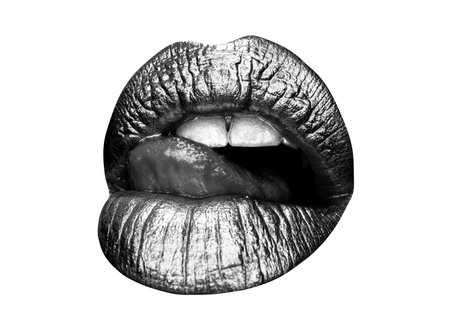 Gold lips. Gold paint from the mouth. Golden lips on woman mouth with make-up. Sensual and creative design for golden metallic. Female gold glitter lipstick.の写真素材