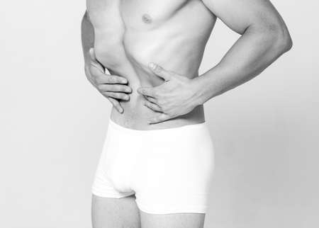 Naked Man slim stomach. Fitness and healthy lifestyle. Males underwear. Vacuum exercise.の写真素材
