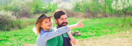 Spring gardening routine. Wife and husband planting in the vegetable garden. Earth concept. Bio food...