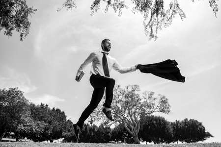 Excited businessman running fast, racing and jumping.の写真素材