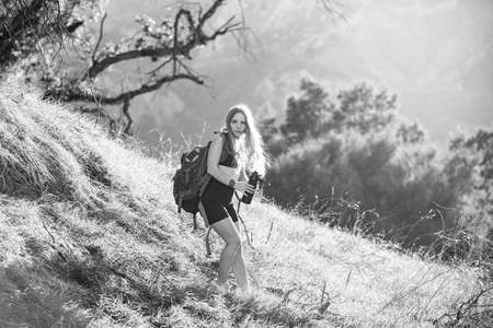 Woman traveler looking at Batur volcano. Indonesia. Female hiker with backpack at mountain. Girl...