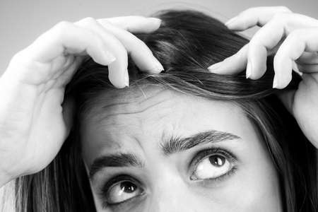 Woman with hair loss problem. Portrait of Young girl with a bald. Head shot of a nervous girl with a...