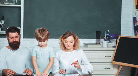 School concept. Nice family photo of little boy and his Parents. Kids gets ready for school. Family...