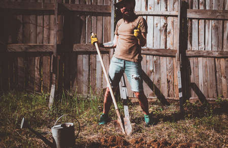 Western cowboy portrait. Full body portrait of funny farmer having fun in a farm.
