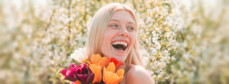 Spring woman face for banner. The idea and concept of happy women on International Womens Day. Laughing girl. Spring blossom background.の写真素材