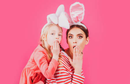 Surprised easter family. Sister girl bunny ears funny little mother kids celebrate. Egg hunt traditional spring holiday.の写真素材