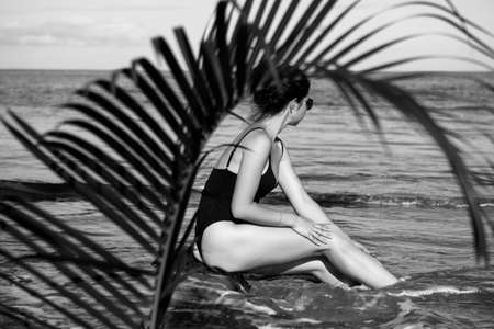 Tropical beach. Sexy bikini body woman on paradise tropical beach having fun. Concept of wellness and travel.の写真素材