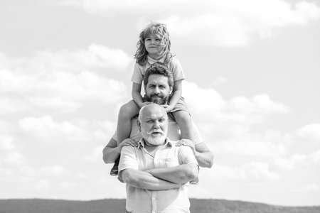 Portrait of men generation grandfather father and grand son outdoor on sky. Fathers day concept. Men...