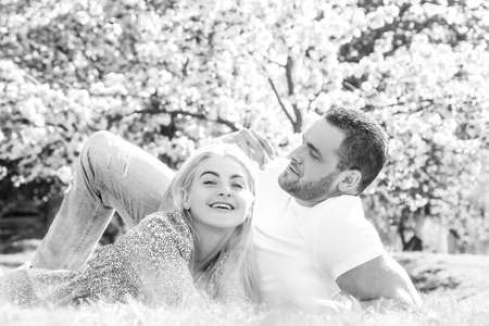 Two young people relaxing in sakura flowers.の写真素材