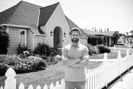 Business man outside near house, rent new home.