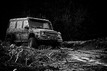 Travel concept with big 4x4 car. Jeep outdoors adventures. Rally racing. Tracks on a muddy field....