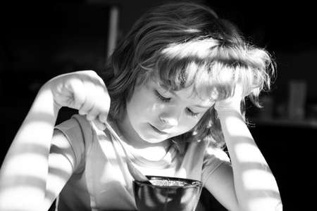 Kids eating. Healthy nutrition. Organic home food. Boy eats breakfast at kitchen.の写真素材