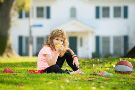 Child boy relax on sport mat after sport exercises outdoor in park. Healthy kids lifestyle.の写真素材