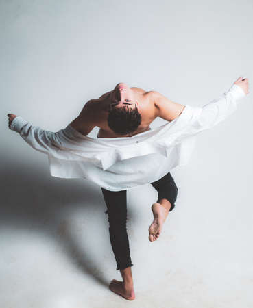 macho man. trendy guy model. fit body. free your mind. sence of freedom. undressing. stylish man with bare chest wear shirt. male fashion and trend. sexy macho. being macho is not so hardの写真素材