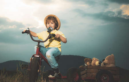 Boy to ride his bike on a country track road. Concept for safety and child development. Concept of...