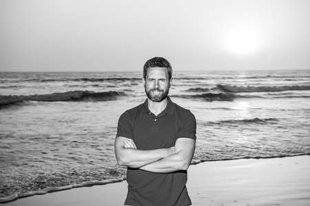 Handsome smiling man enjoying summer day on the beach.の写真素材