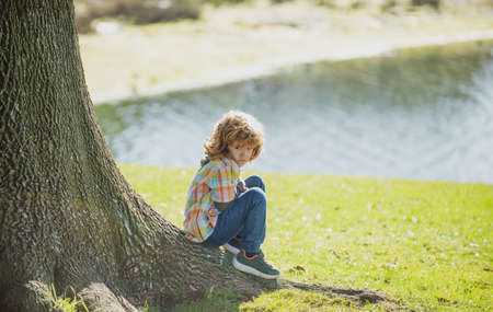 Negative kids emotion. Loneliness. Child sad. Kids adaptation. Lonely boy.の写真素材