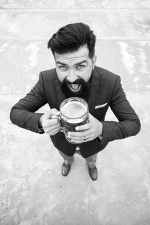 Funny man in classical suit holding glass with beer in hand. Smiling man with beer. Bartender, happy brewer. Full length, wide angle. Expression emotions.の写真素材