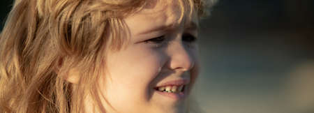 Closeup face of child boy crying outdoor. Tears on kids face closeup.の写真素材