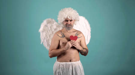 Crazy angel man with heart. Valentin angel man with wings. Funny Valentines day celebration.の写真素材