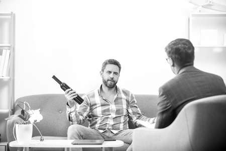 Man with psychologist theraphy social problems concept alcohol addiction.