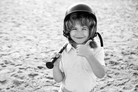 Child playing Baseball. Batter in youth league getting a hit. Boy kid hitting a baseball. Thumbs up.
