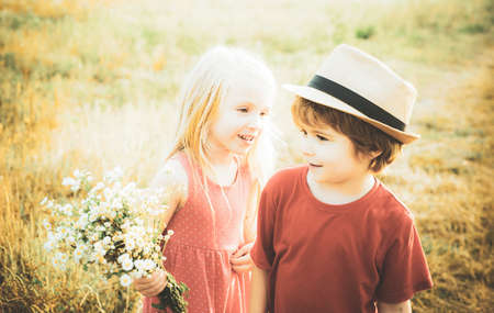 Beautiful little couple - boy and girl embracing. Childhood concept. Summer portrait of happy cute child. Romantic and love. Love concept. First love. Happy Valentines day.の写真素材