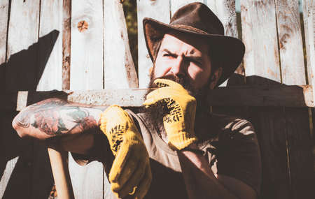 Portrait of Farmer in the farm on countryside background. Rural scene. Eco farm worker. Western cowboy portrait.の写真素材