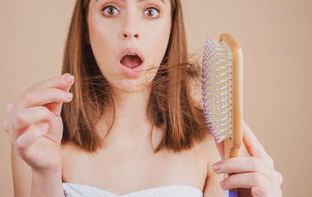 Hair loss woman with a comb and problem hair. Hairloss and bald problems concept.の写真素材