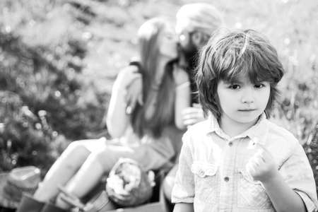 Family on picnic outdoor. Parents with kid in garden or park. Parenthood together leisure. Wife and...