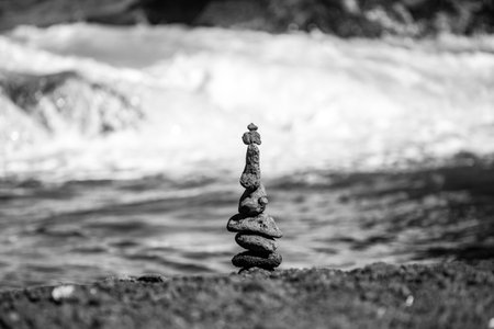 Pyramid of sea pebbles on beach. Life balance and harmony concept. Balancing nature.