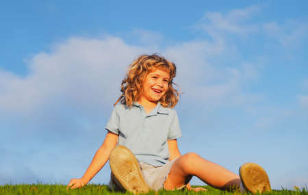 Kid on nature summer field. Active family leisure with kids. Child fun outdoors.