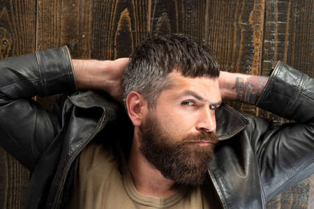 Man, handsome serious male model. Bearded guy relaxing, dreaming.の写真素材