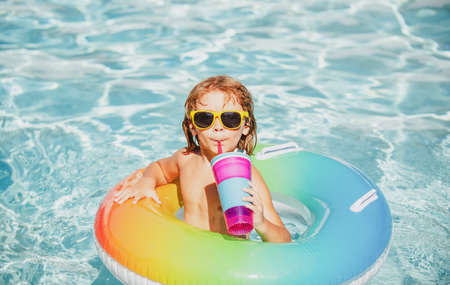 Summertime vacation. Summer child weekend. Boy in swiming pool. Kid at aquapark. Funny boy on...