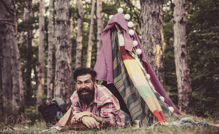 Travel recreational outdoor activity concept. Play tent. Summer camping on nature. Summer camp. Camping in improvised wooden house in nature.の写真素材