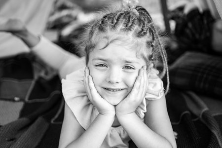 Smiling girl in tent. Kid playing in tent. Kids camping. Having fun outdoors. Campground. Funny face close up.の写真素材