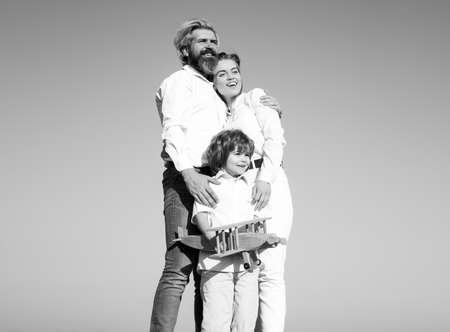 Family day outdoor. Boy with young parents. Motherhood fatherhood. Son dad mother. Family with...