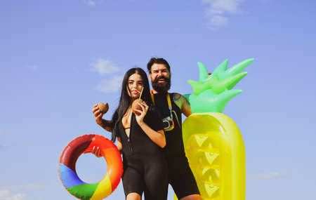 Couple at beach summer vacation. Sexy woman in swimsuit. Summertime concept. Man in swimsuit.