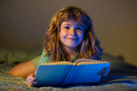 Child boy reading book. Kids reading story. Happy child boy reading books, playing at home, reads...
