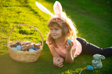 Children celebrating easter. Kid in rabbit costume with bunny ears outdoor. Funny boy, easter bunny kids.の写真素材