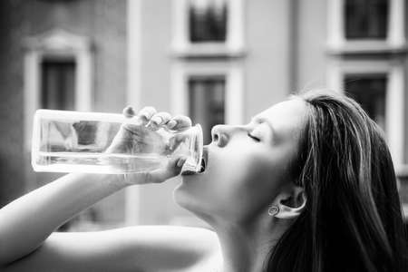 Woman drinking water. Sensual young girl outdoor. Stay hydrated. City portrait. Fashion and beauty. Luxury street style vogue.の写真素材