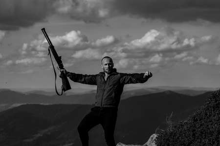 Excited Hunter with his rifle. Nature places for hunting. Hunter with shotgun gun after a hunt....