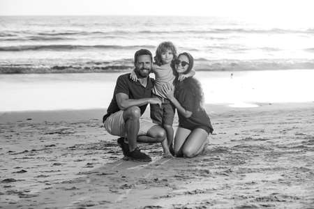 Happy family hugging on beach. Family outdoors.の写真素材