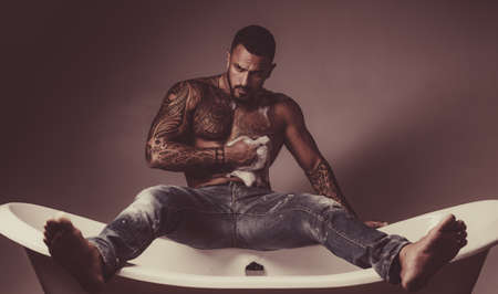 Male care. Sexy of handsome topless male model. Men bodycare. Men with well-groomed male body. Sexy mele on bathroom. Body care.の写真素材