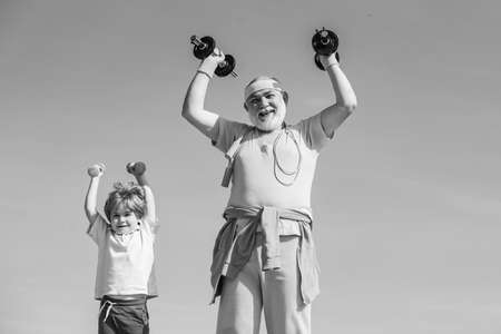 Grandfather and son doing exercises. Father and children having workout. Senior man and child in...
